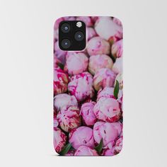 a bunch of pink flowers with green stems in the center on a white phone case