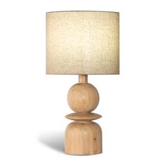 a wooden table lamp with a white shade on it's base and a beige linen lampshade