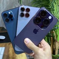 three new iphones are being held up in front of each other, with the same color