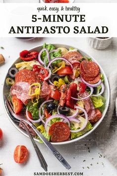 a salad with tomatoes, olives and pepperoni in it