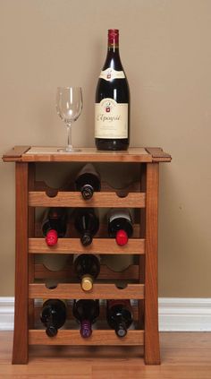 a wooden wine rack with bottles and glasses