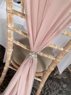 the back of a chair covered in pink fabric