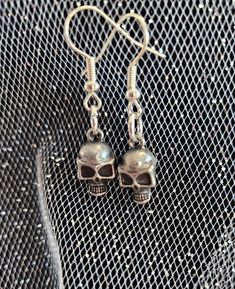 Metal skull charm on silver earring hooks, handmade Halloween Skull Jewelry With Ear Wire, Gothic Skull Jewelry With Ear Wire, Adjustable Skull Shaped Earrings With Ear Wire, Metal Skull Earrings With Ear Wire, Silver Skull Earrings With Ear Wire, Skull Shaped Metal Earrings For Gifts, Handmade Silver Skull Jewelry, Nickel Free Metal Skull Earrings, Skull-shaped Metal Earrings With Ear Wire