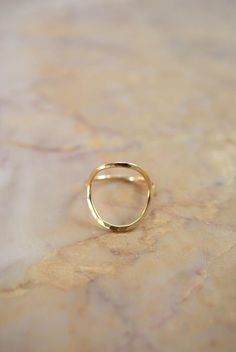 This item is made to order and will ship after 7-10 business days. That time does not include holidays, weekends or shipping time!This item is hand-crafted by the designer herself and made to order in Portland, OR.This Skinny Gold Infinity ring is definitely a new favorite! I twist a length of 14kt Gold metal into a circular shape and lightly hammer it. The hammered effect adds lots of shine and sparkle, so even through the wire itself is very light and feminine, the ring has a big impact overal Hammered 14k Gold Stackable Rings, Modern Hammered Yellow Gold Rings, Modern Hammered Stackable Rings, 14k Gold Open Circle Rings, Elegant Yellow Gold Open Circle Ring, Elegant Hammered Round Rings, Elegant Gold Open Circle Ring, Elegant 14k Gold Open Circle Rings, Elegant Everyday Open Circle Rings