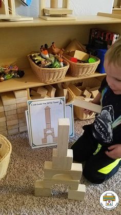 a young boy playing with wooden blocks in his playroom