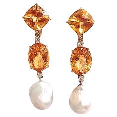 Bespoke 18kt Yellow Gold Elegant Three Stone Drop Earrings with two Citrine and Baroque Pearl and Diamonds Faceted Cushion, Oval, and then Baroque Pearl finished with four diamonds ~0.60cts. These earrings measure 2 1/2" in length and 1/2" wide. These earrings can be made for Clip or Pierced earrings. The Bespoke Collection is made to order to your ring size. You may select whichever color stones you would like to match your outfit or your mood! Please contact us with any questions you may have. Color Stones, Pear Diamond, Pierced Earrings, Baroque Pearls, Three Stone, Earings Piercings, Citrine, Clip On Earrings, Stone Color