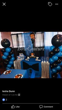 the table is set up with blue and black balloons