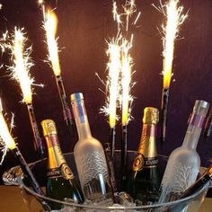 there are many bottles in the ice bucket with sparklers