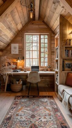 a home office with wood paneling and a rug on the floor in front of a window