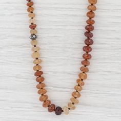 "This lovely new necklace is an authentic Nina Nguyen piece. This necklace has a retail price of $495. Gem: Multi-Colored Gold Hessonite Garnet Beads Metal: Sterling Silver Weight: 80.1 Grams Stamps: Nina Nguyen 925 N Style: Bead Strand Closure: Lobster Clasp Length: 39 1/2 - 43 1/2\" Width: 7.8 mm Approximate Each piece is thoroughly examined and refinished as needed by our professional jewelers, graded by our in-house GIA (Gemological Institute of America) Graduate Gemologist, and inspected fo Artisan Gemstone Rondelle Necklace, Artisan Brown Single Strand Jewelry, Spiritual Brown Necklace With Faceted Beads, Artisan Brown Necklaces With Faceted Beads, Brown Single Strand Necklace, Artisan Amber Single Strand Necklace, Artisan Brown Necklace With Faceted Beads, Artisan Amber Necklace Single Strand, Traditional Multi-strand Polished Beads Necklace