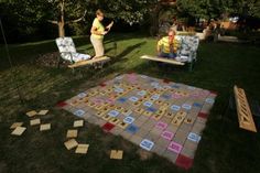 two people sitting on lawn chairs in front of a board game