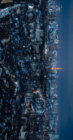 an aerial view of the city at night from above, looking down on skyscrapers