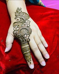 the hand is decorated with henna designs