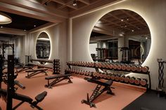 a gym with rows of exercise equipment and mirrors