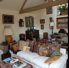 a living room filled with furniture and pictures on the wall