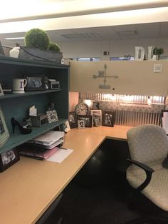 an office with a desk, chair and bookshelf in the middle of it