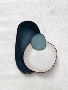 two blue and white plates sitting on top of each other in the shape of a heart