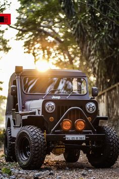 the jeep is parked on the side of the road in front of some trees and bushes