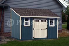 a blue and white garage with two windows