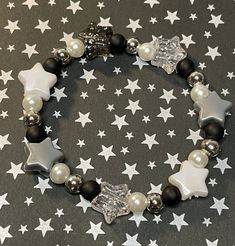 Get lost in a galaxy far away with this plastic Star beaded bracelet. Accented with glass pearl and silver colored spacer beads is sure to add an out of this world sparkle to your park day outfit!   Bracelets are available in a variety of lengths.  Pick your custom length from the drop down menu below.  All our bracelets are made with quality in mind.  With that being said, all bracelets should be treated with care while putting on, wearing, and taking off.  Keep dry. Do not swim or bath with th Pretty Bead Jewelry, Bracelet With Stars, Star Bracelet Diy, Beaded Star Bracelet, Star Bracelet Bead, Star Beads Bracelet, Silver Beads Bracelet, Alt Bracelets, Bracelet Ideas Glass Beads