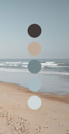 a beach with footprints in the sand and an image of circles hanging from it's sides