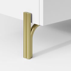 a white cabinet with a gold handle on it