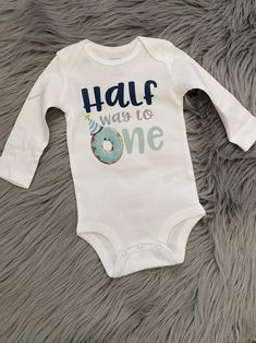 a baby bodysuit that says,'half way to one'on the front