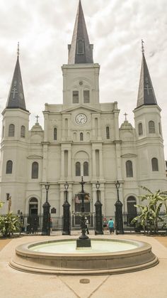 a large white building with two towers and a clock