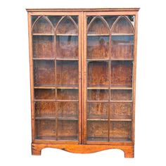 an old wooden bookcase with glass doors