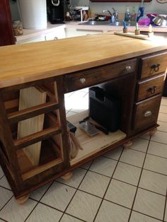 a kitchen island made out of wood with drawers