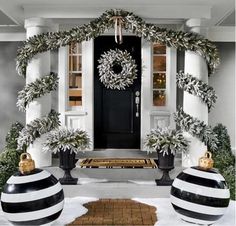 a black and white front porch decorated for christmas