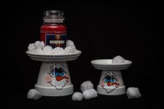 two white dishes filled with cotton balls and a jar