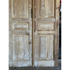 an old pair of wooden doors with peeling paint