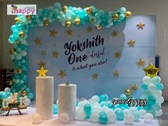 balloons and stars are on display in front of a backdrop that says yonkth one is what you are