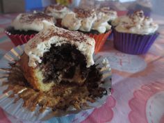 several cupcakes with frosting and sprinkles are on a paper plate