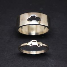 two wedding rings, one with a car on it