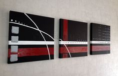 three black and red paintings hanging on the wall