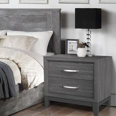 a bedroom scene with focus on the bed and nightstand