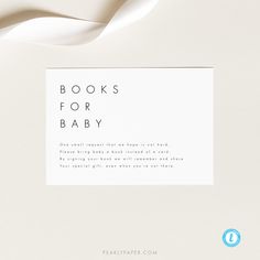 there is a book for baby on the cover and it has a white ribbon in front of it