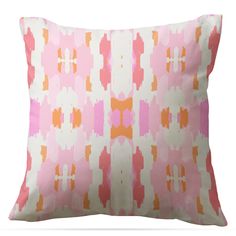 a pink and orange pillow with an abstract design on the front, sitting against a white background