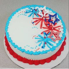 a cake with red, white and blue frosting on the top is decorated with stars