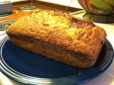 a loaf of bread sitting on top of a blue plate next to a stovetop