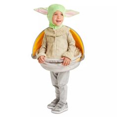 a young child dressed in an infant yoda costume