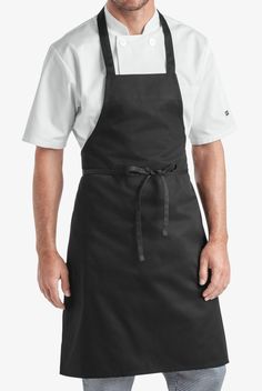 a man in an apron is posing for the camera with his hands on his hips