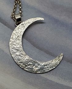 big moon pendant silver, Crescent Moon Pendant, celestial jewelry, unique moon necklace silver, unique gift for women, moon talisman silver  Large crescent moon pendant, fully handmade from sterling silver. Awesome pendant for men and women alike. This pendant was structured with a unique texture that makes it look almost like the real moon! The pendant itself is 1 1/2 inches long, and 1 inch wide. To make this necklace perfect for you, you can select the length of the sterling silver necklace. Silver Moon Necklace With Sun And Moon Design, Silver Half Moon Necklace With Sun And Moon Design, Handmade Silver Crescent Necklace, Silver Crescent Necklace With Sun And Moon Design, Silver Moon Necklace With Oxidized Finish, Handmade Silver Half Moon Jewelry, Silver Moon Print Round Jewelry, Handmade Half Moon Silver Jewelry, Silver Oxidized Moon Shaped Jewelry