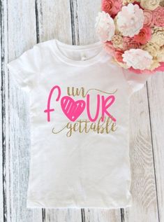 a white shirt with pink and gold lettering on it