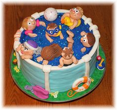 there is a cake that looks like an inflatable pool with many people inside