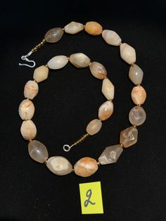 A beautiful string of Bended white agate natural found from Afghanistan dating 1800 yrs. They are found at that time in Afghanistan mostly but also some found in India and Pakistan too. They were used as a special charm jewellery by the affluents at that time period. Beautiful counter bronze are decorated further in between the beads. Spiritual Round Chalcedony Bead Jewelry, Spiritual Tumbled Agate Jewelry, Rondelle Agate Jewelry With Natural Stones, Agate Rondelle Natural Stone Jewelry, Oval Agate Gemstone Bead Necklaces, Oval Agate Gemstone Beaded Necklaces, Chalcedony Gemstone Beads For Jewelry Making, Vintage Agate Jewelry For Healing, Agate Jewelry With Oval Gemstone Beads