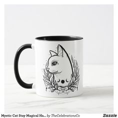 a black and white coffee mug with a cat's face on it