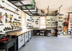 a garage filled with lots of tools and equipment on the wall next to each other